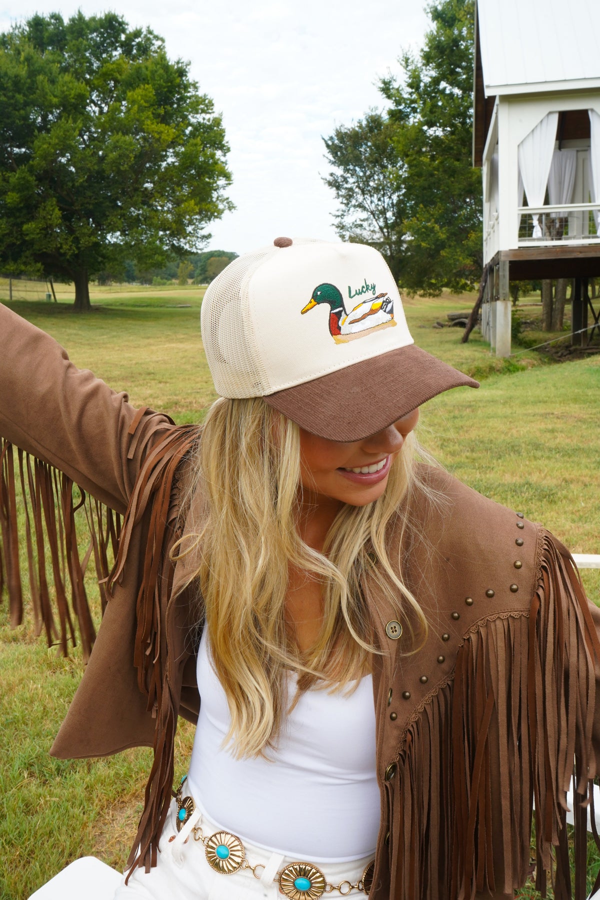 Brown-corduroy trucker hat with white mesh panels and front duck patch logo.