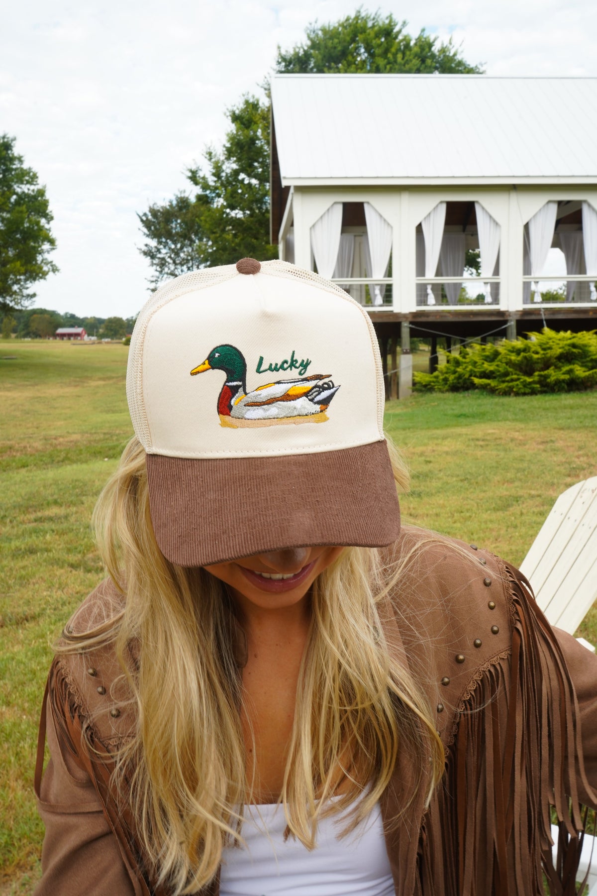 Brown corduroy trucker hat with white front panel and duck logo embroidery.