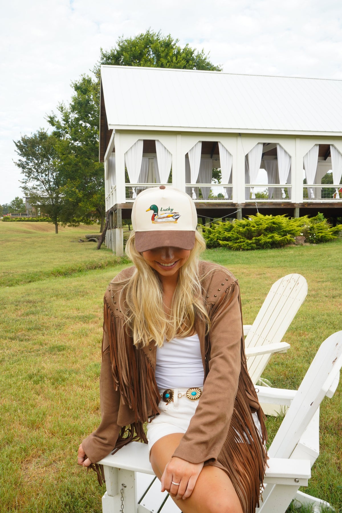 Brown corduroy trucker cap with white front panel and embroidered duck graphic.