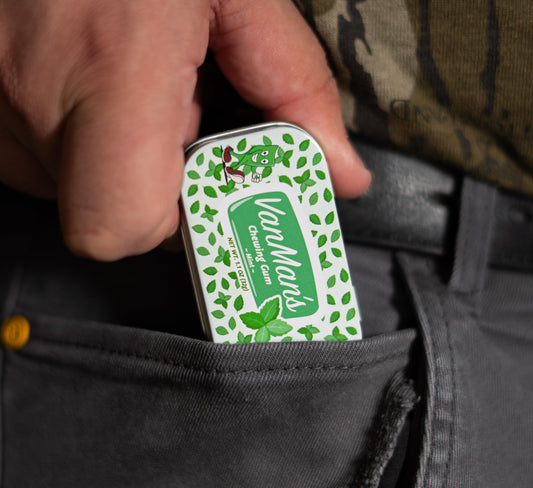 Mint remineralizing chewing gum tin held in hand
