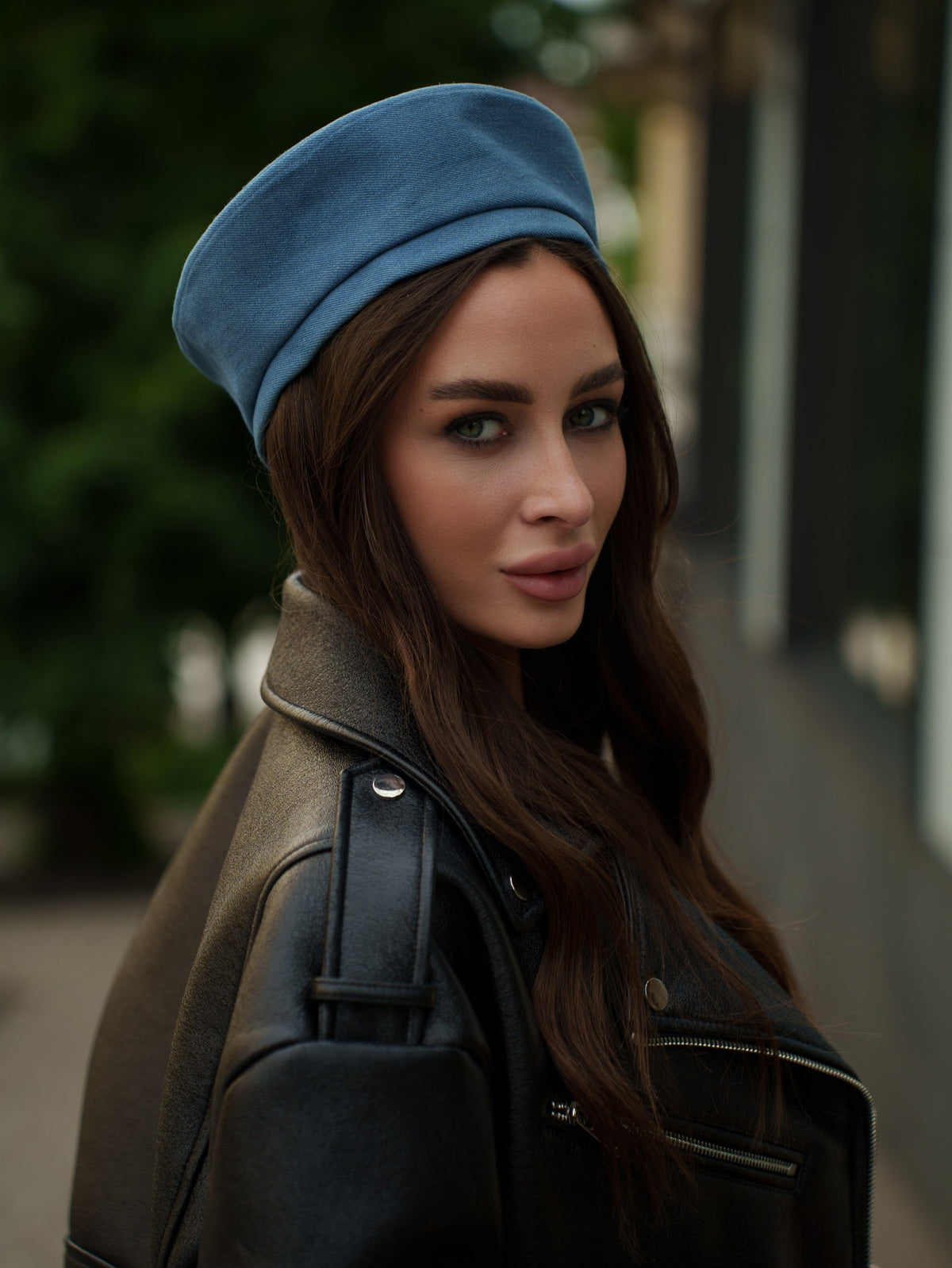 Blue Paris hat with a rounded crown and short brim, worn at an angle.