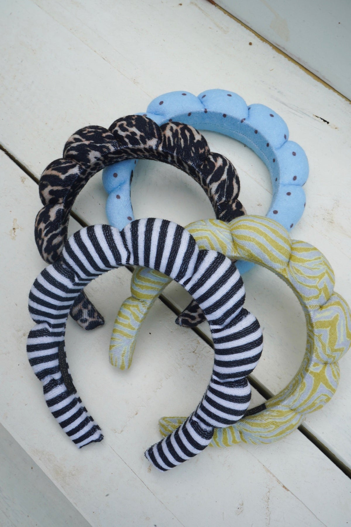 Plush braided headbands with black leopard, blue scallop, and navy-and-white striped loop