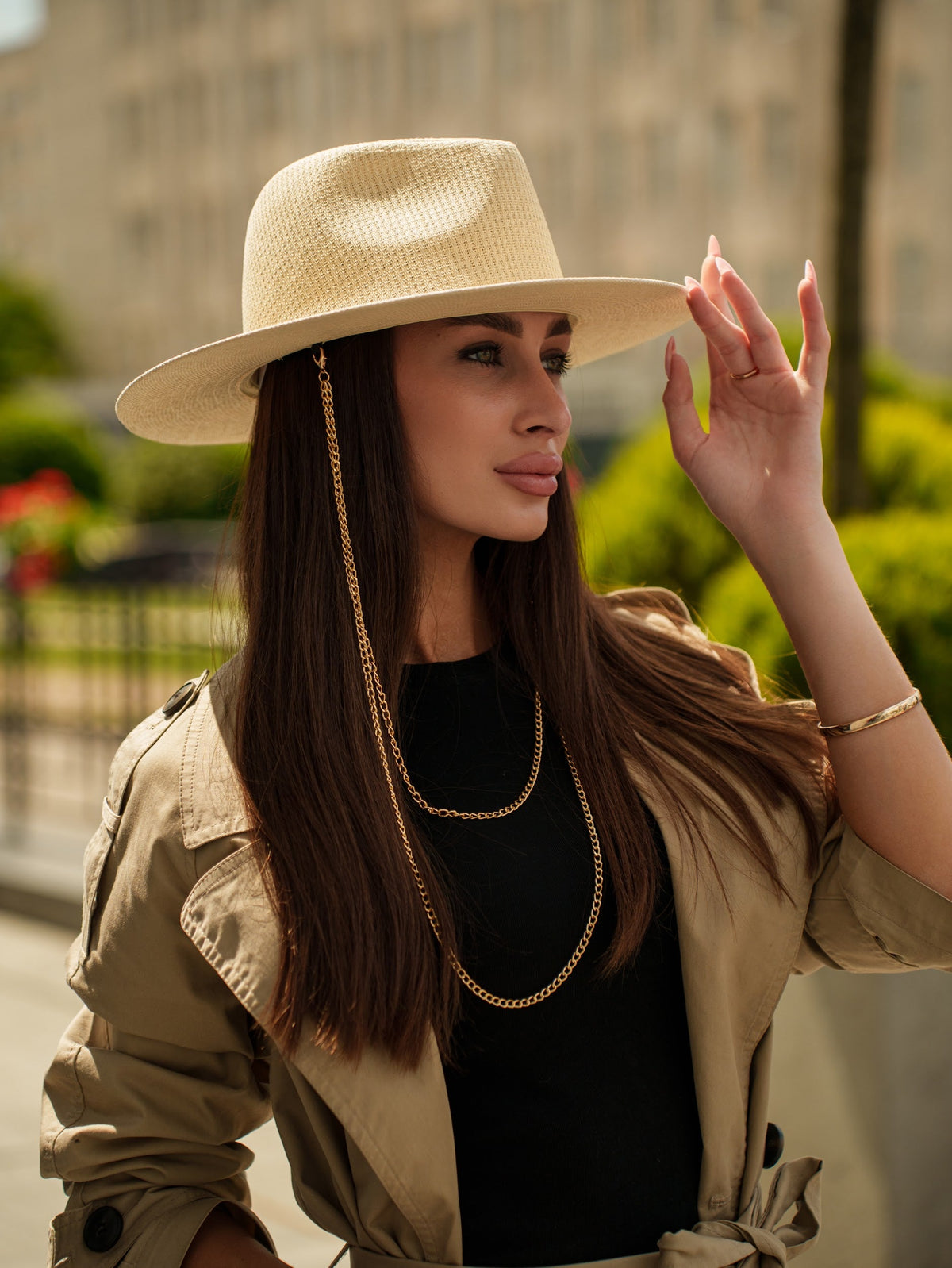 Tribli beige paper straw hat with a wide brim and gold chain trim, worn from the front