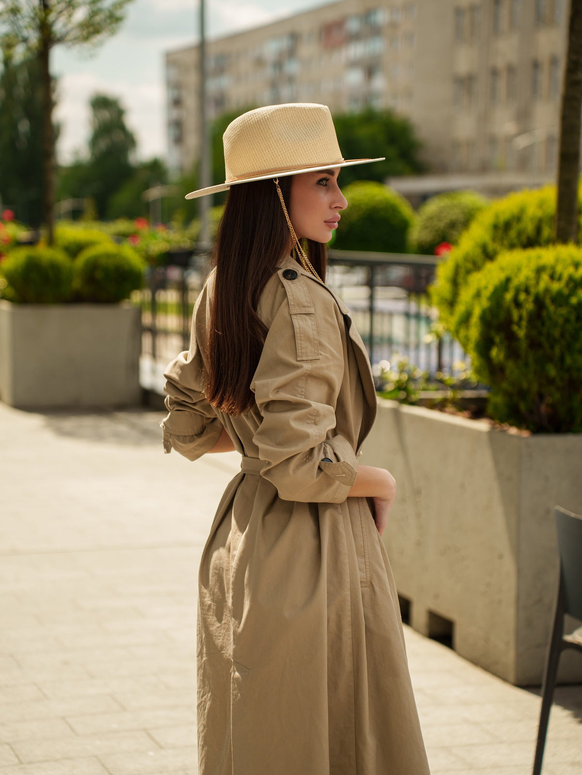 Tribli beige paper straw hat in profile, with a flat wide brim and chain detail