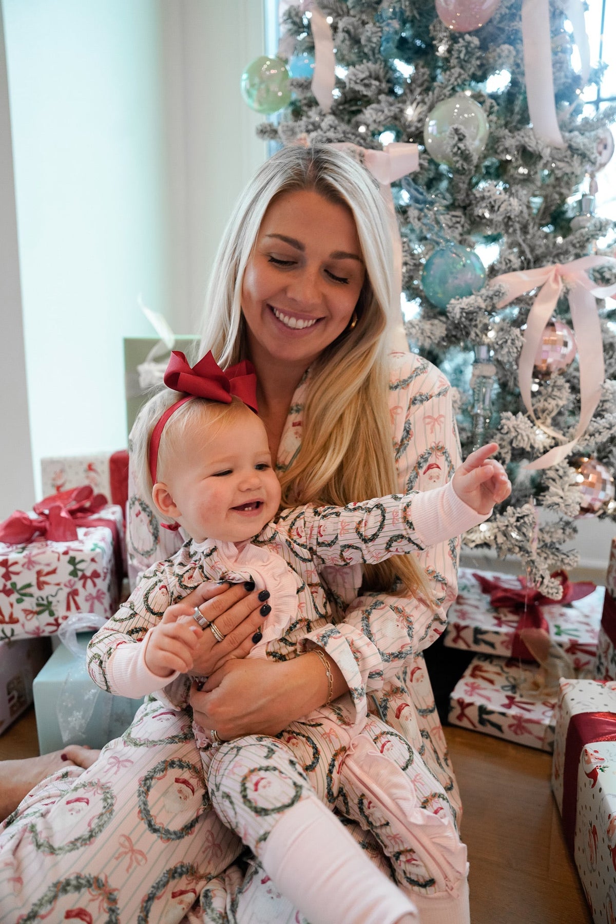 Pink patterned hooded pajama set with matching long pants, woman holding child