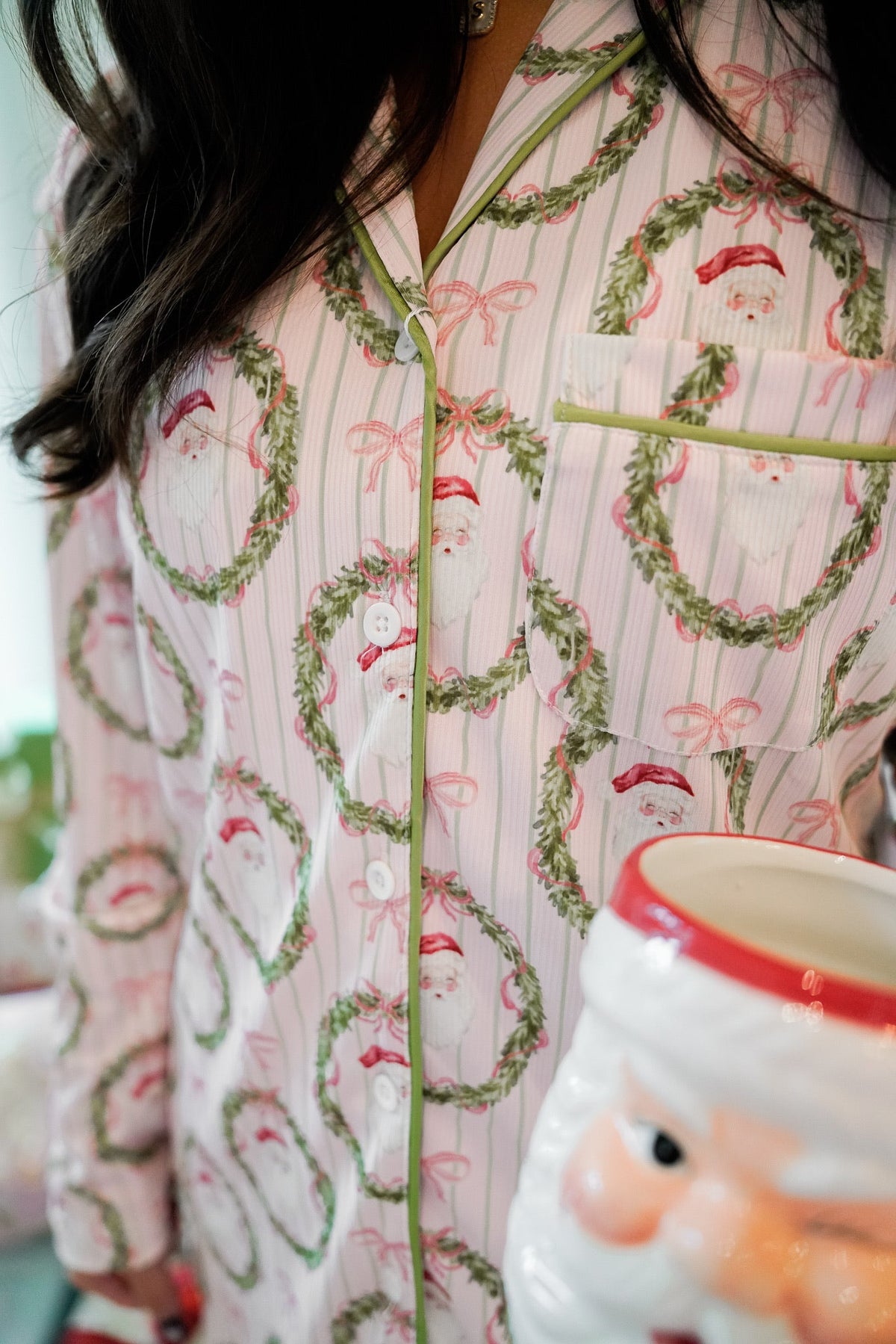 Santa and wreath print long-sleeve button pajama top with vertical pink striped texture.