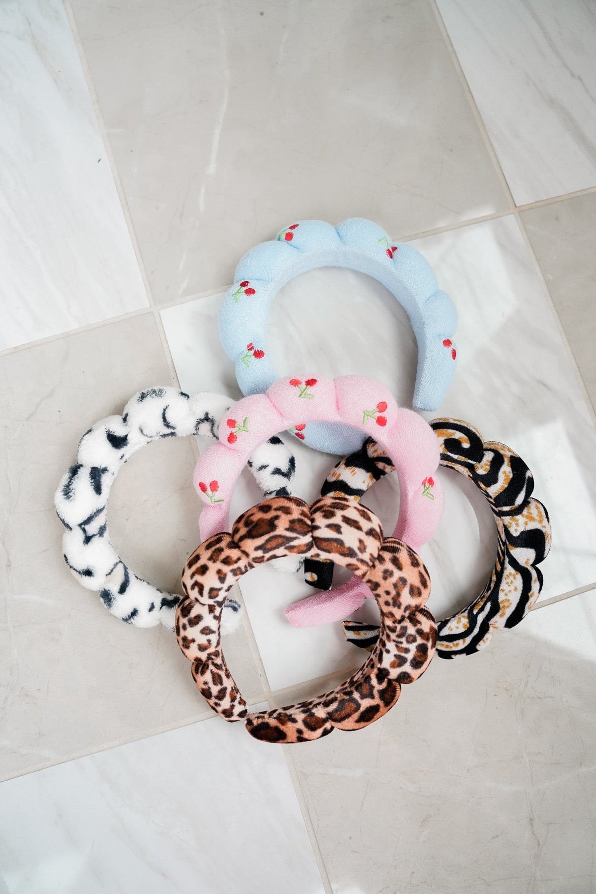 Plush braided headbands with light blue, pink cherry, leopard print, and zebra details