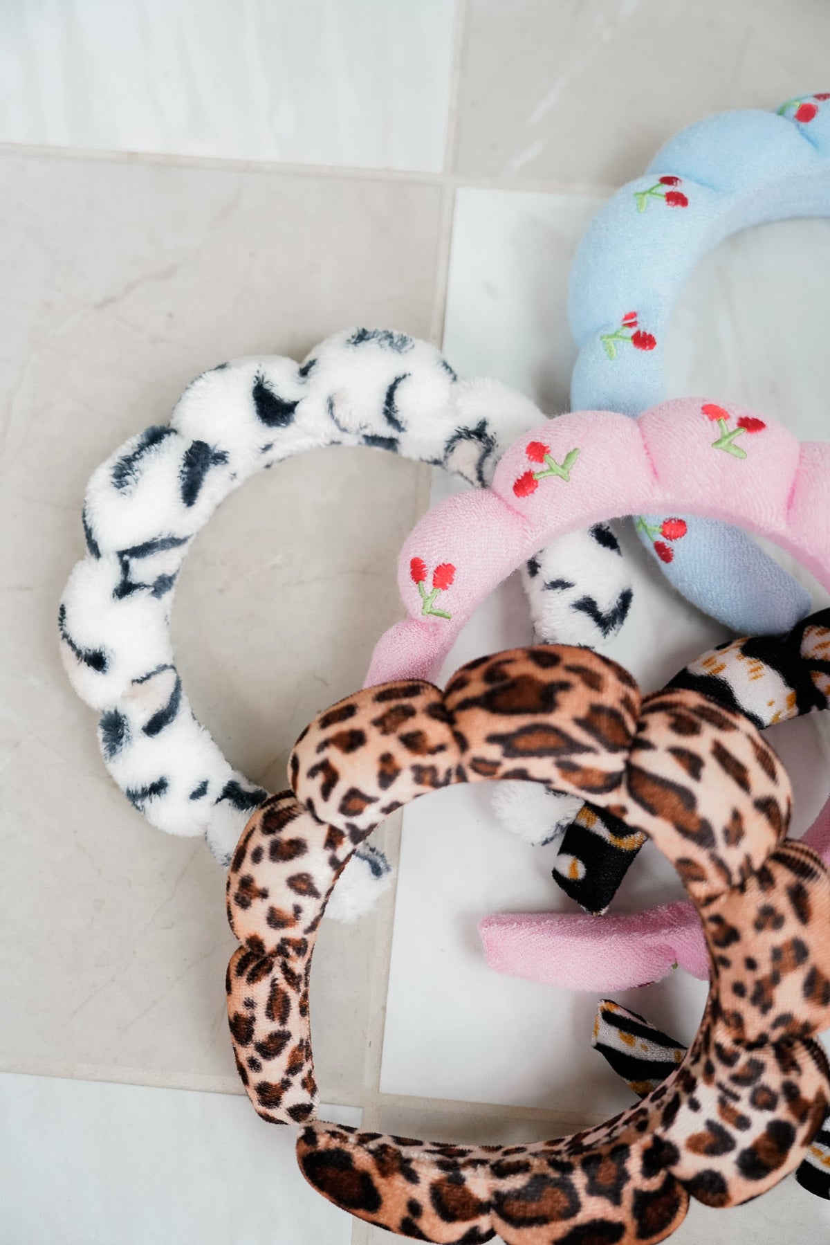 Plush fabric headbands set with blue, leopard-print, and white patterned loops