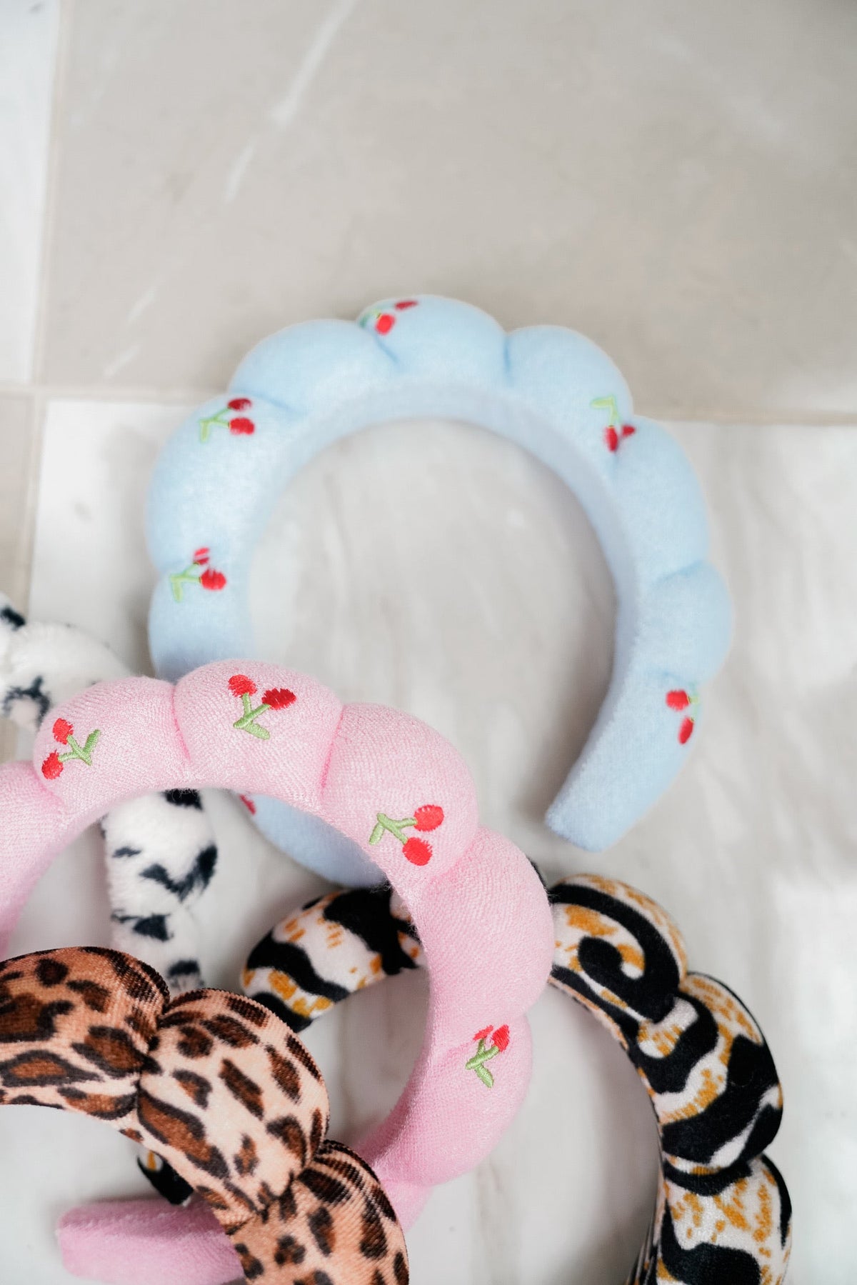Plush headbands with light blue floral pattern and pink cherry print with leopard mix