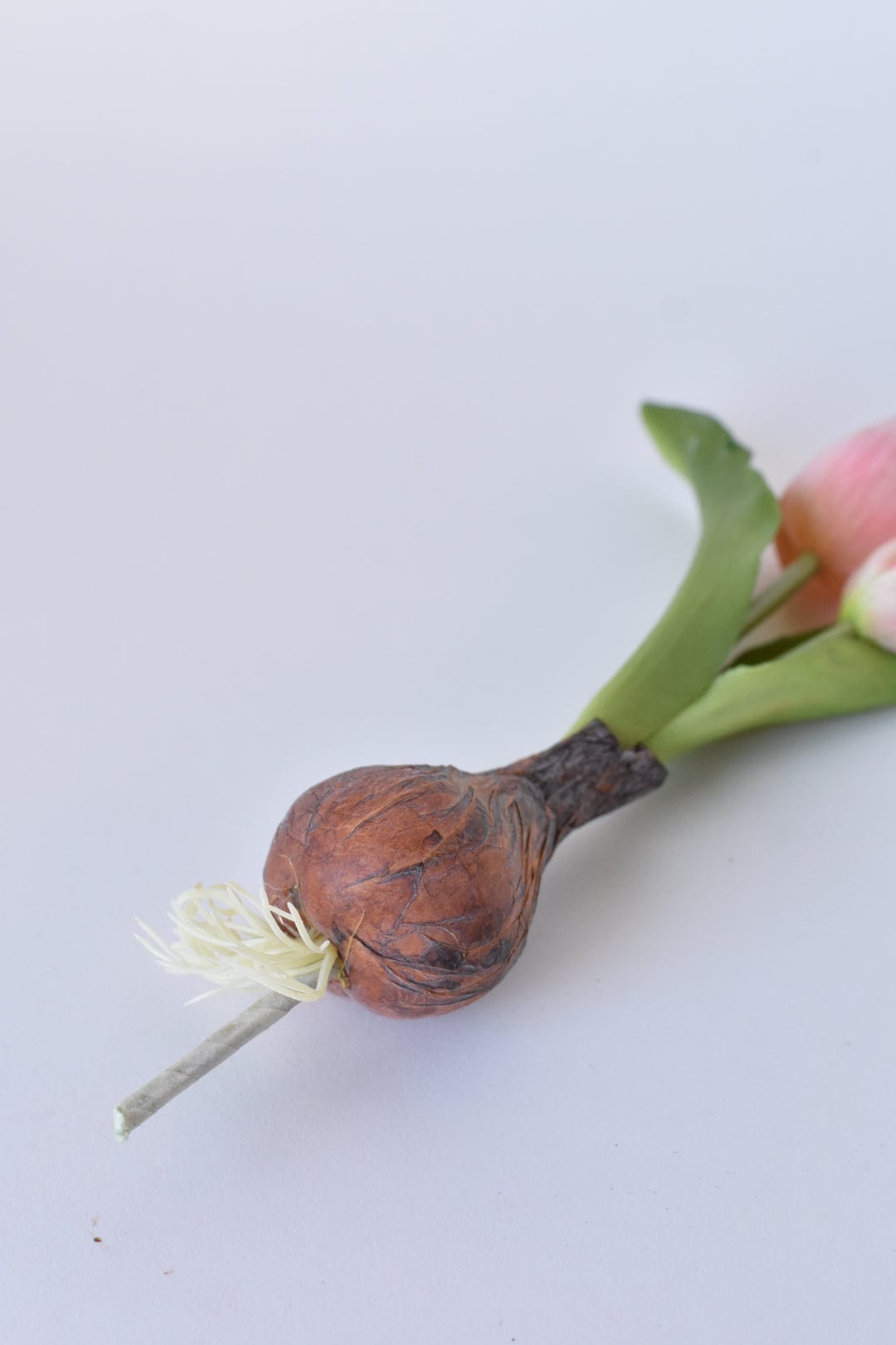Faux bulb with roots and attached stem pick end
