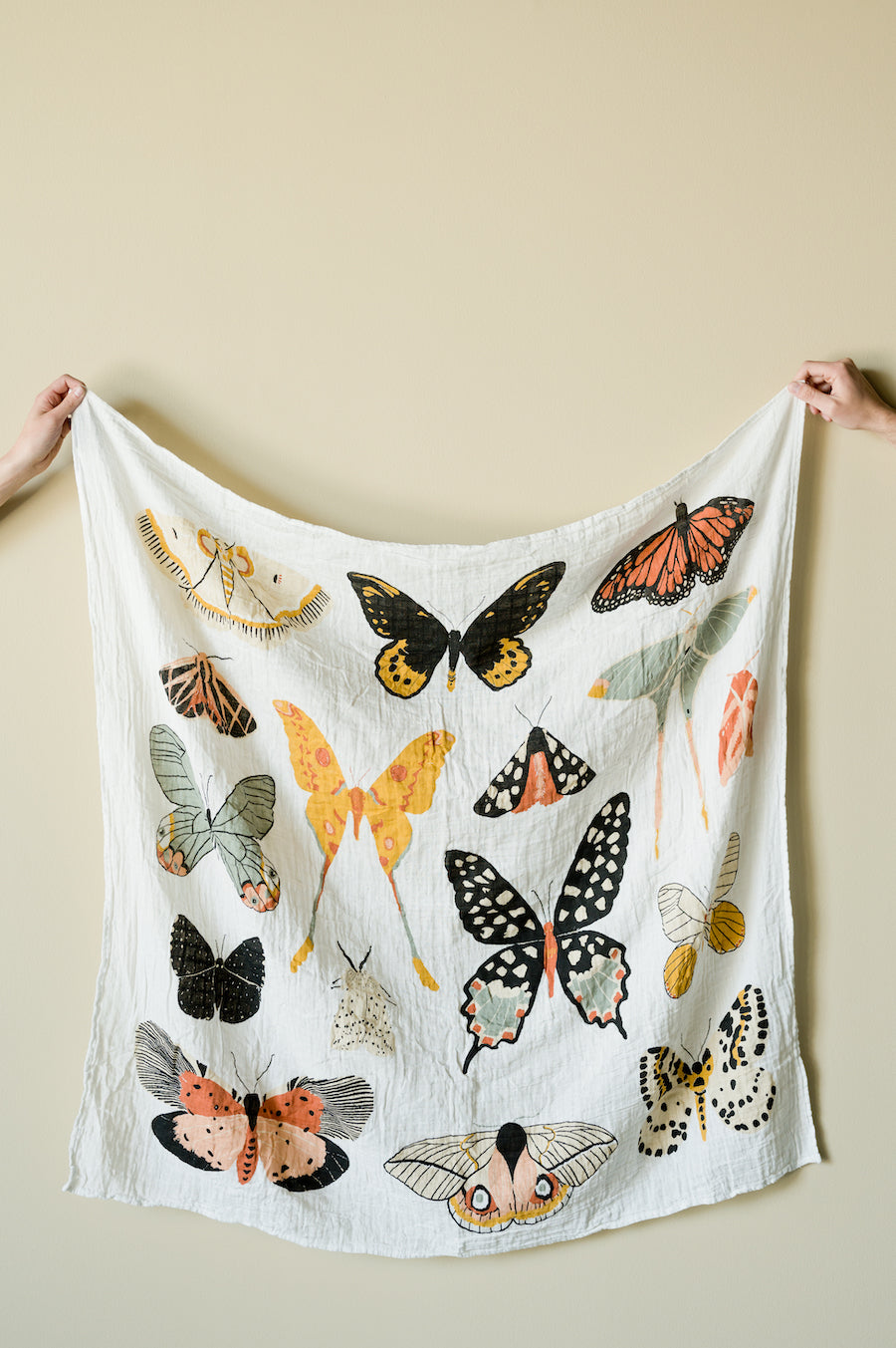 Butterfly print baby swaddle blanket, white with orange and black moths and butterflies