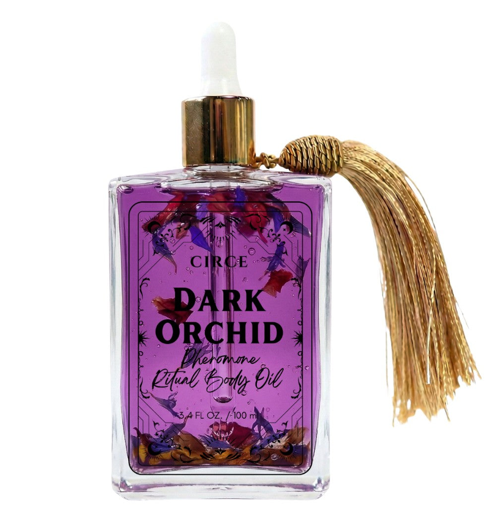 Dark Orchid body oil in a purple glass bottle with gold dropper cap and tassel