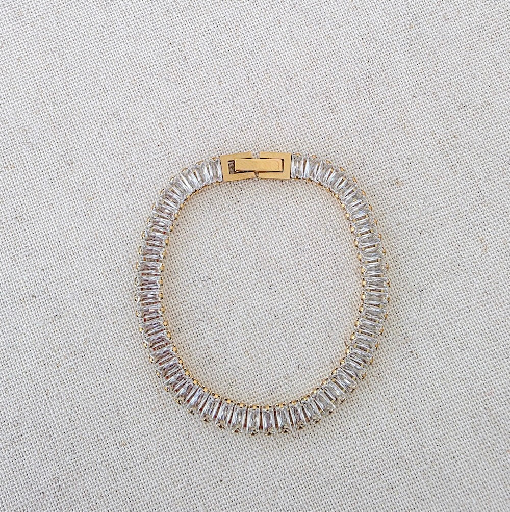Silver-tone rhinestone bracelet with gold clasp and clear stones