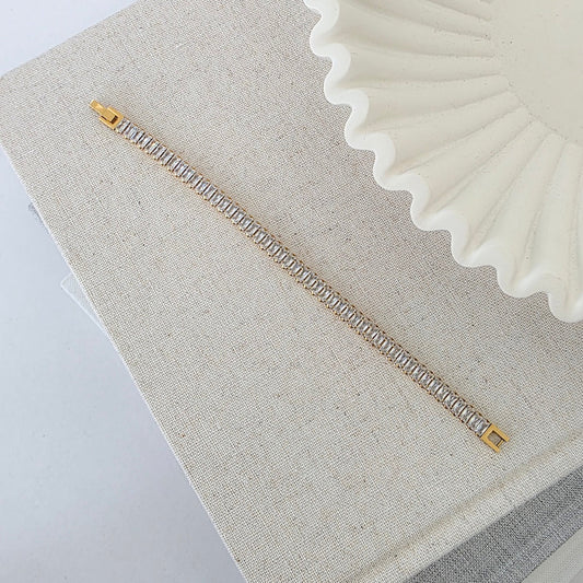 Rhinestone tennis bracelet with gold clasp and clear rectangular stones