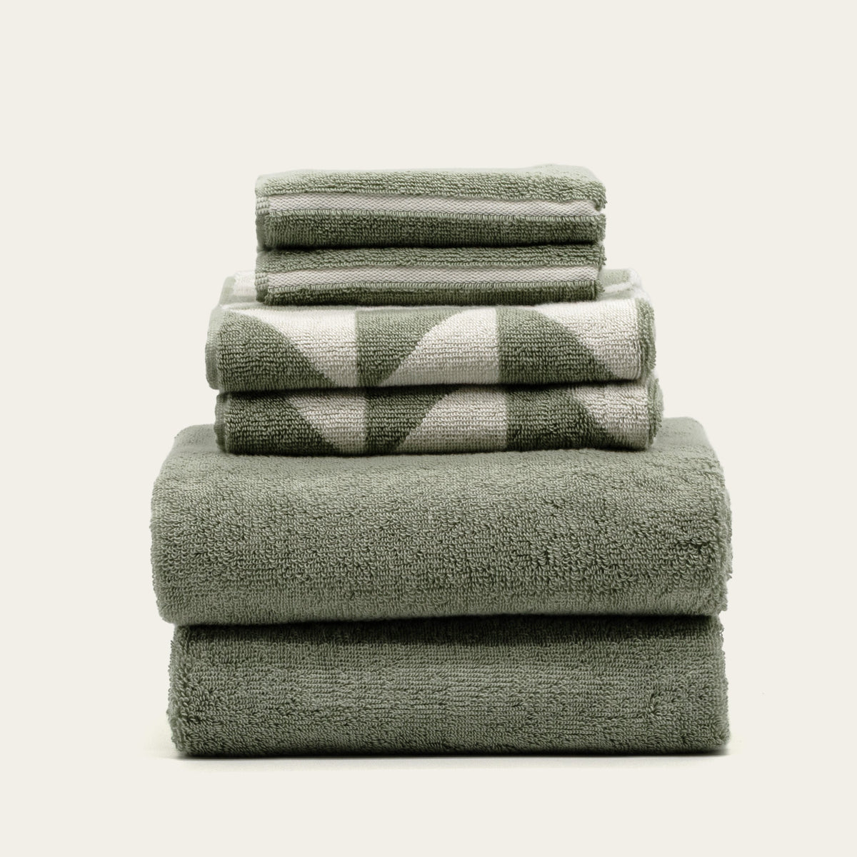 Green and ecru geometric-check cotton towels stack with plush terry texture