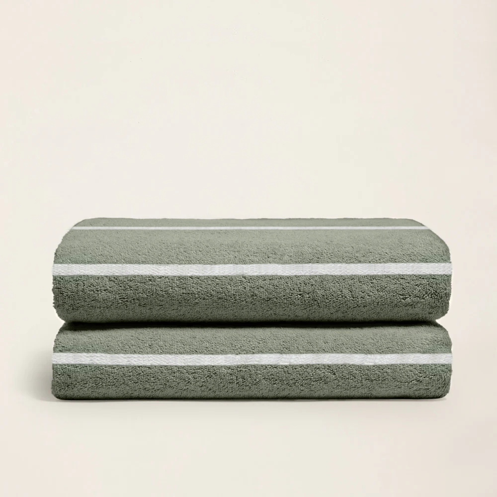 Sage green cotton towel with ecru horizontal stripes, folded