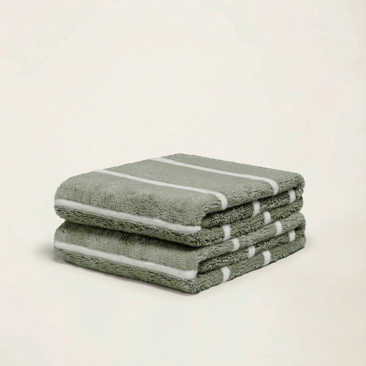 Sage-green cotton towels with white stripe edging, folded stack of 3