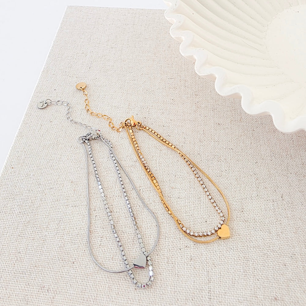 Set of gold and silver tennis-style bracelets with round disc charm and extender chain
