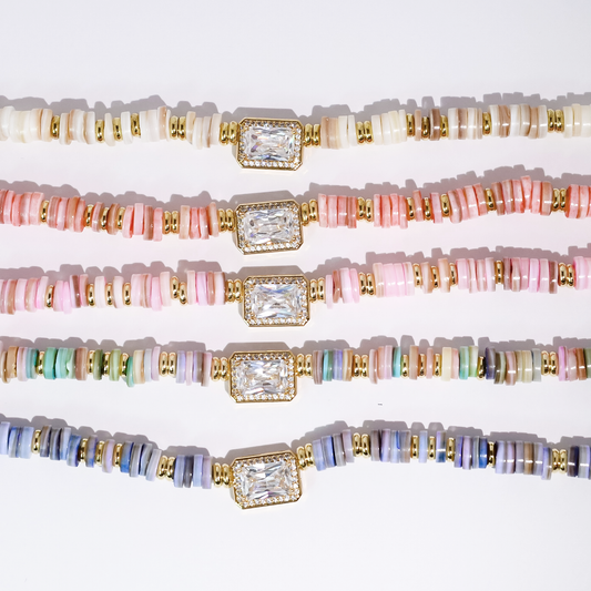 Gemstone beaded necklace with gold-toned square centerpiece and multicolor heishi beads.