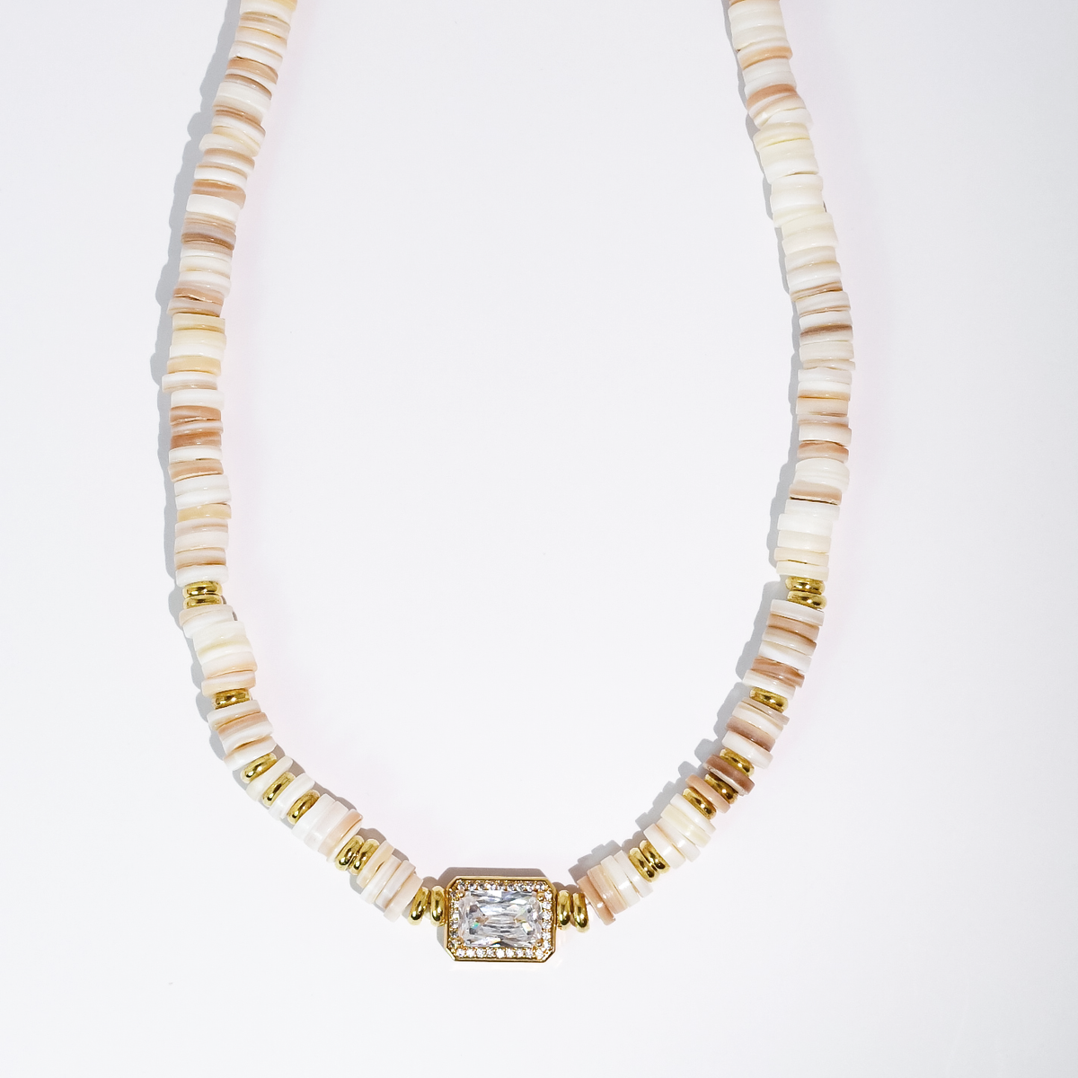 Cream heishi beaded necklace with gold-toned square gem pendant and ribbed spacer beads.