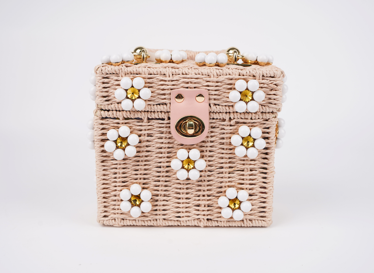 Pink woven handbag with white beaded flowers, gold clasp and top handle