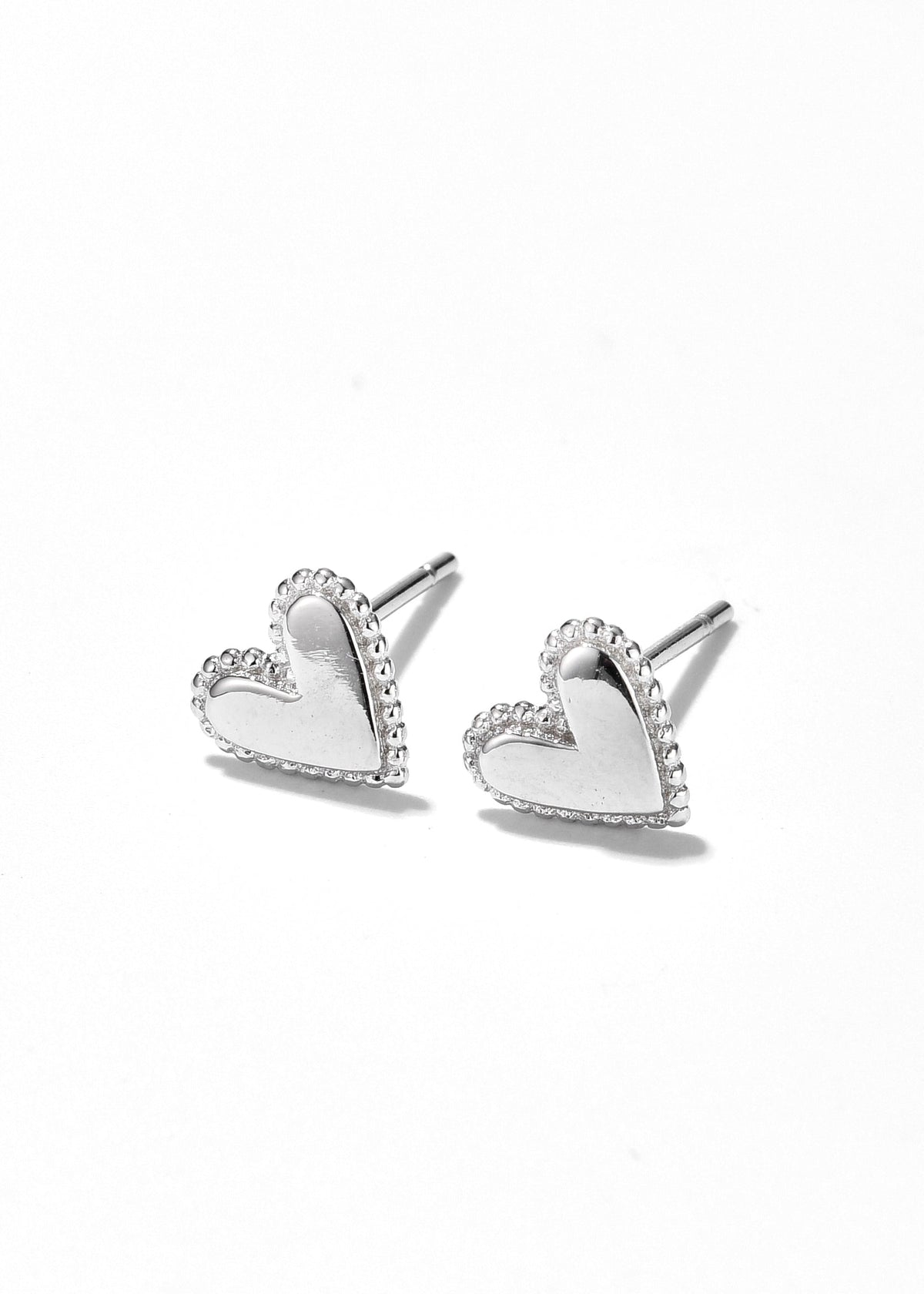White gold heart stud earrings with dotted borders and smooth centers