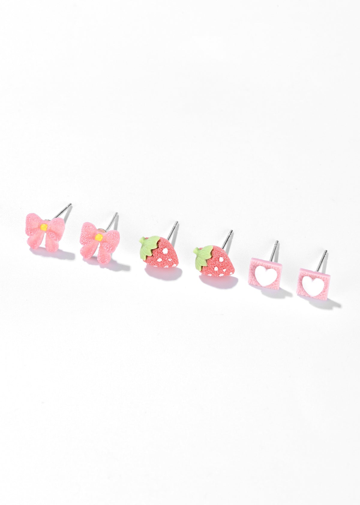 Pink stud earrings in three designs: flowers, strawberries, and hearts