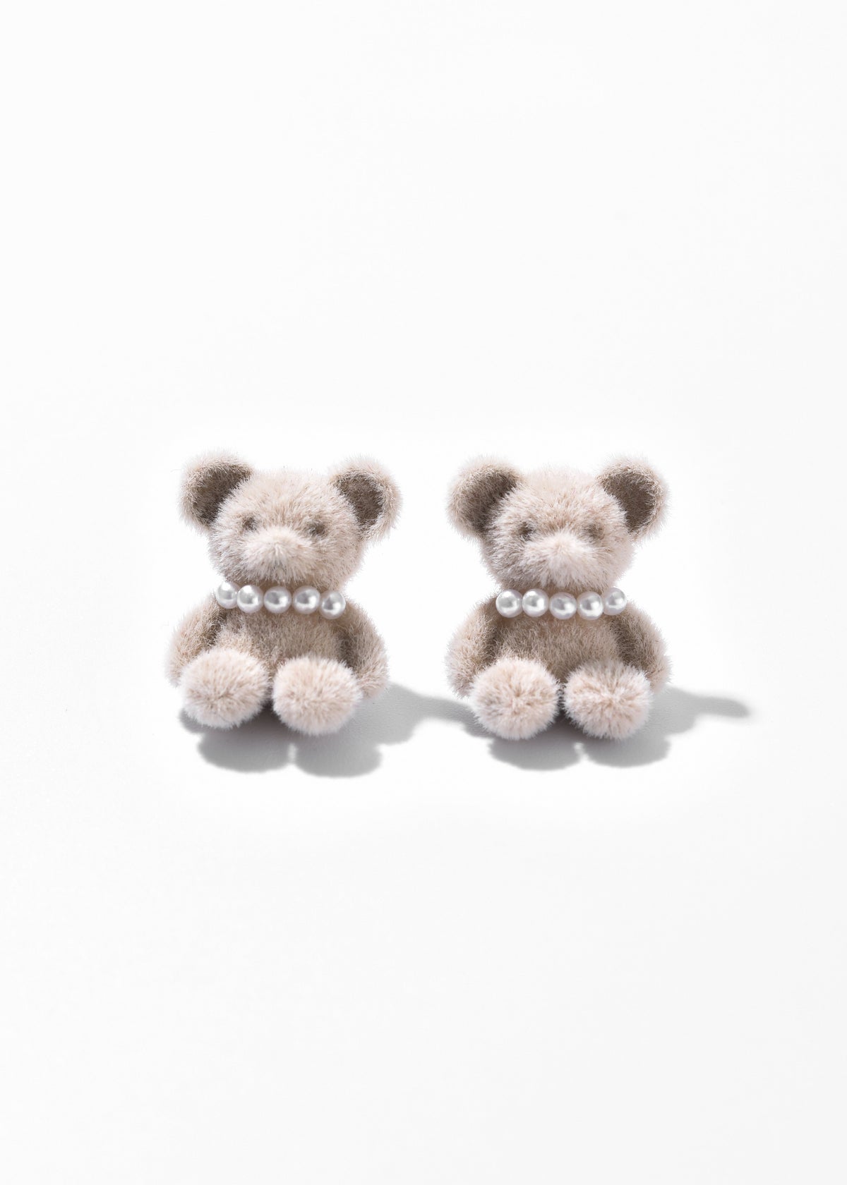 Pair of oatmeal teddy bear earrings with pearl-like collars