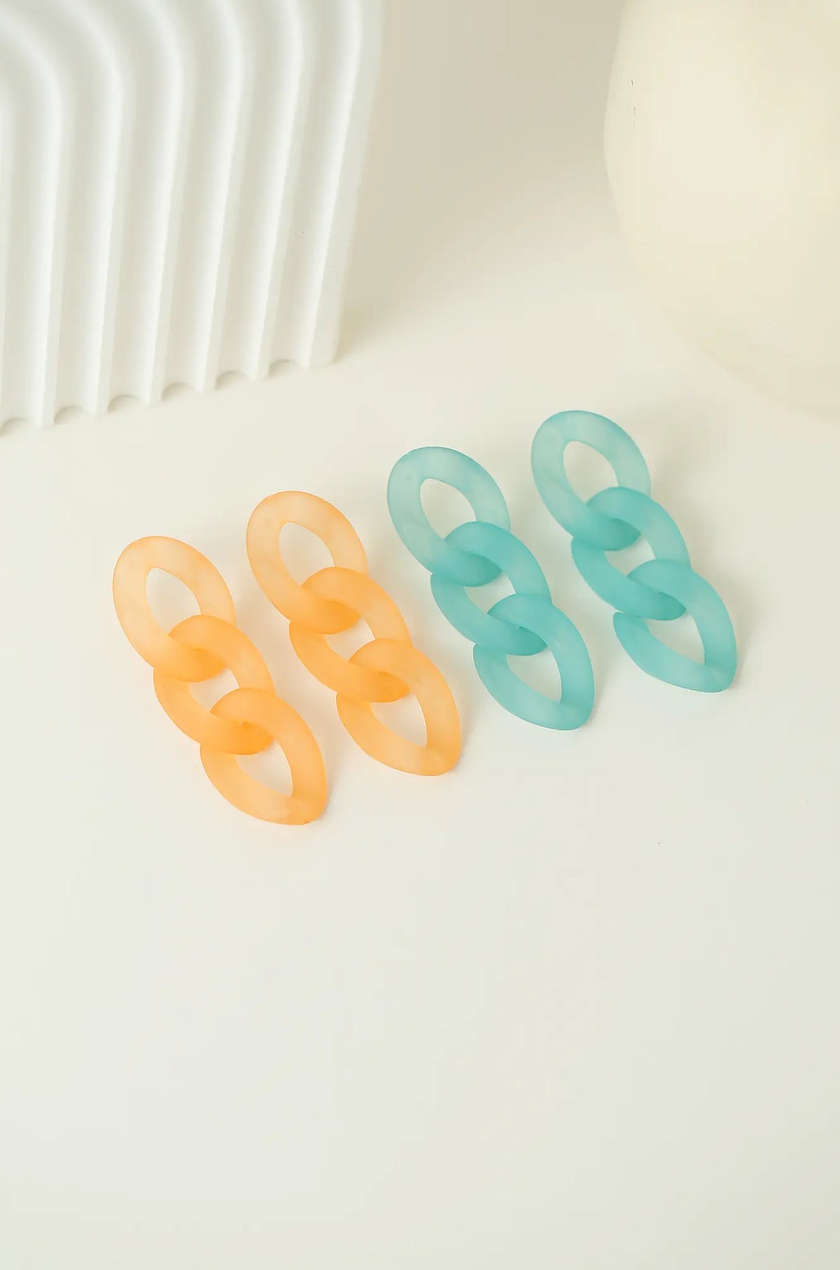 Three-link earrings in orange and teal