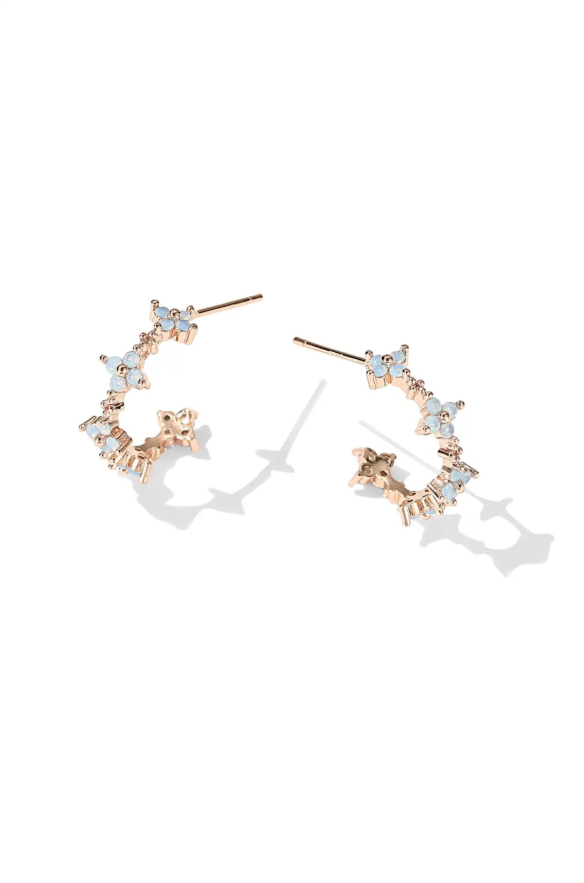 Rose gold flower hoop earrings with pale blue stones and clear accents