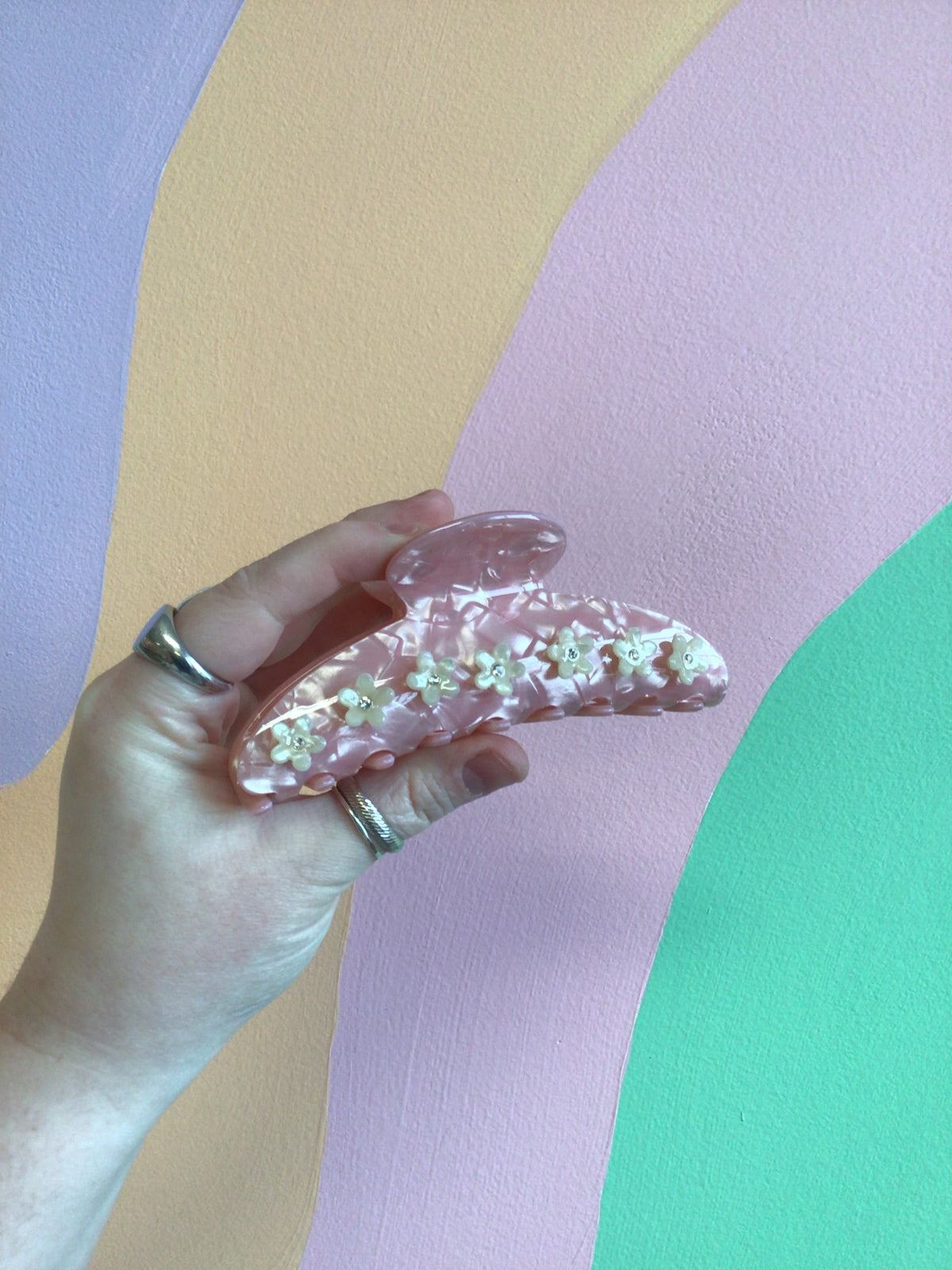 Appliqué flower hair claw clip in pink translucent plastic with tiny flowers