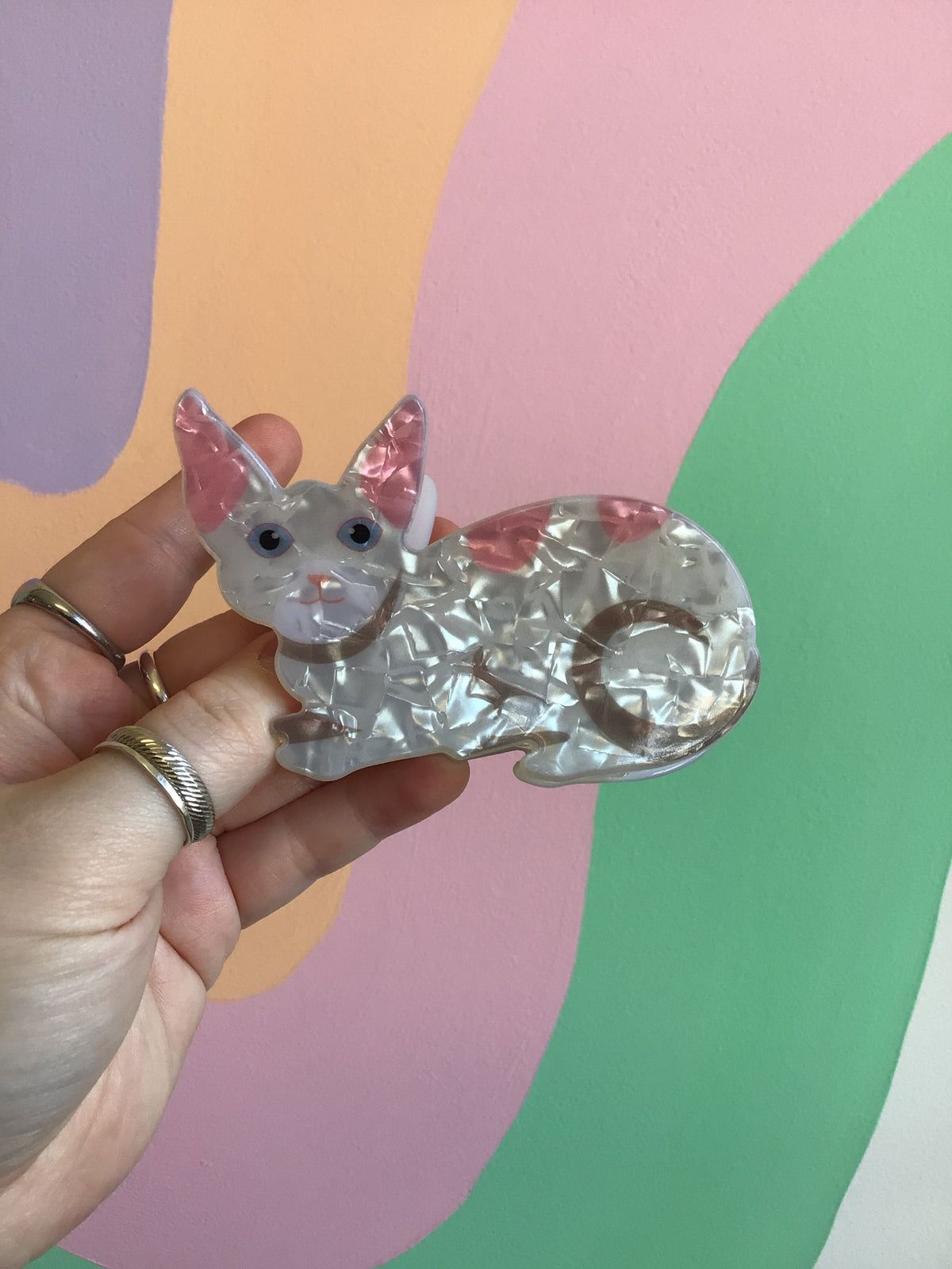 Clear white cat hair claw with blue eyes, pink ears, and cute gray nose