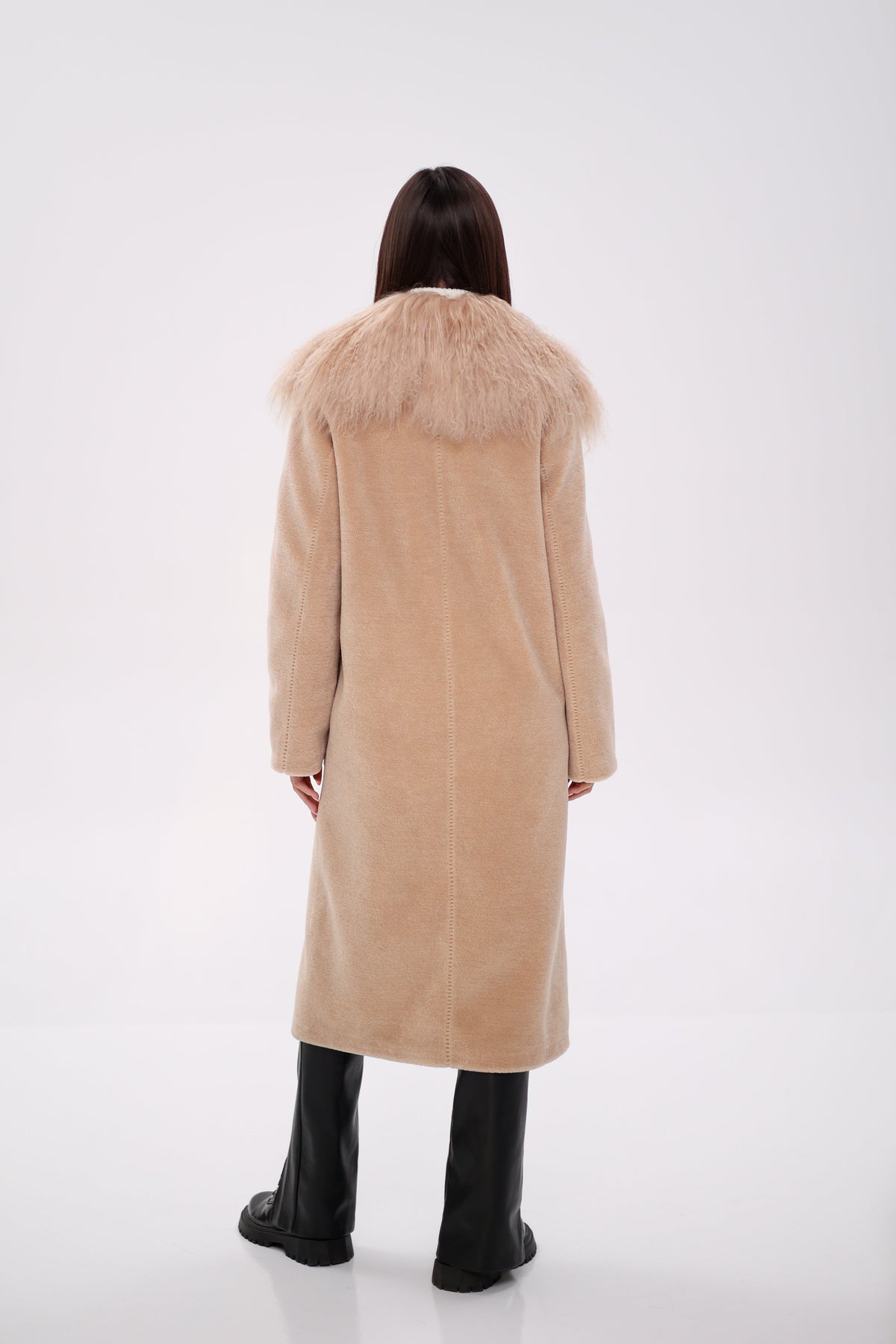 Back view of a long beige coat with a wide fur collar