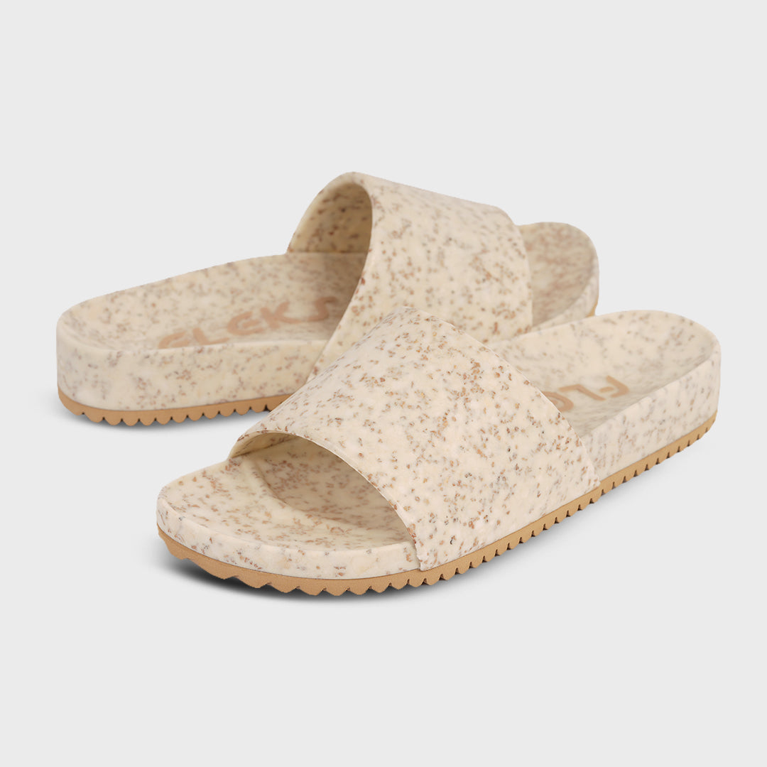 Speckled slide sandals with open toe crossover straps and textured tan sole.