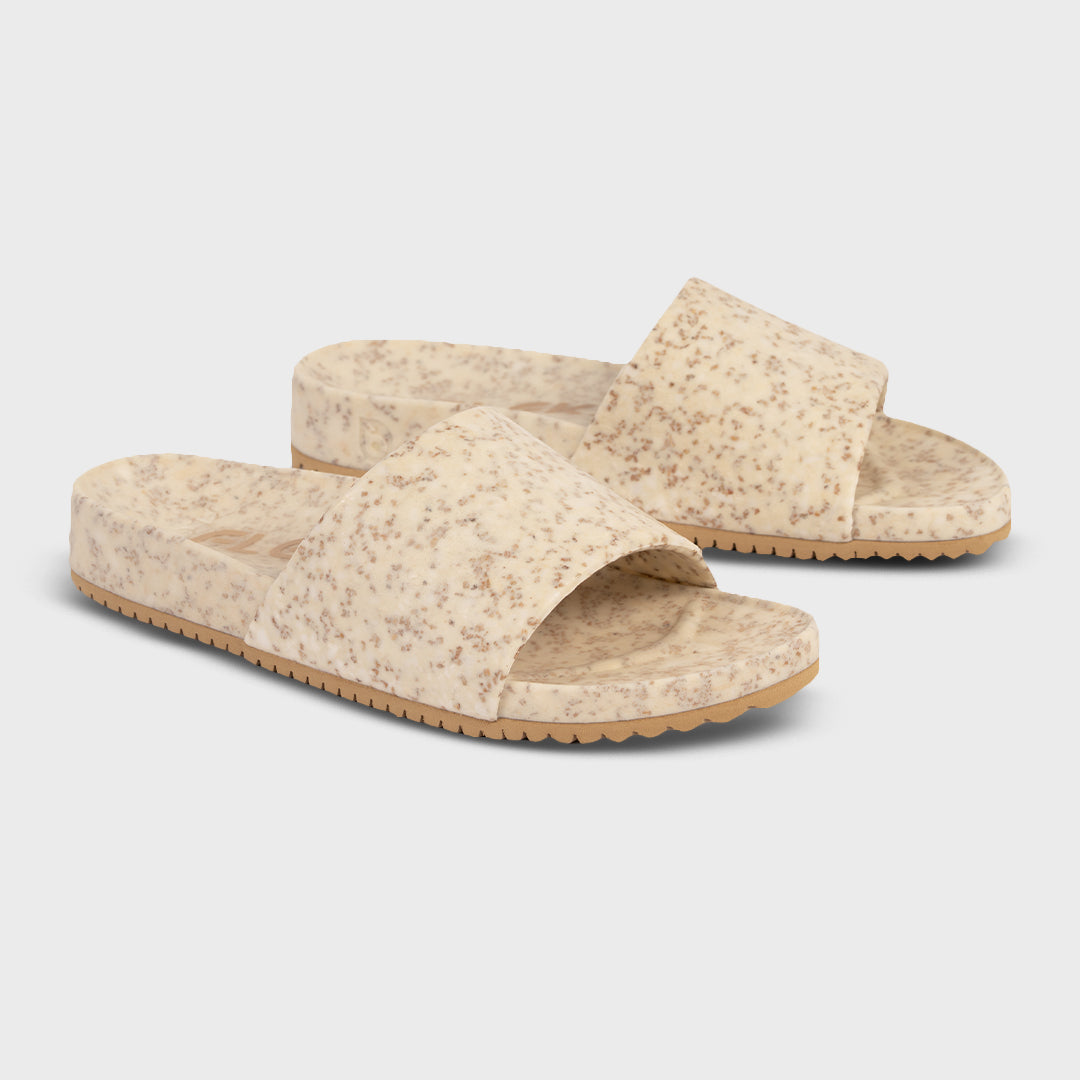 Speckled open-toe slide sandals, crossover upper and textured tan platform sole.