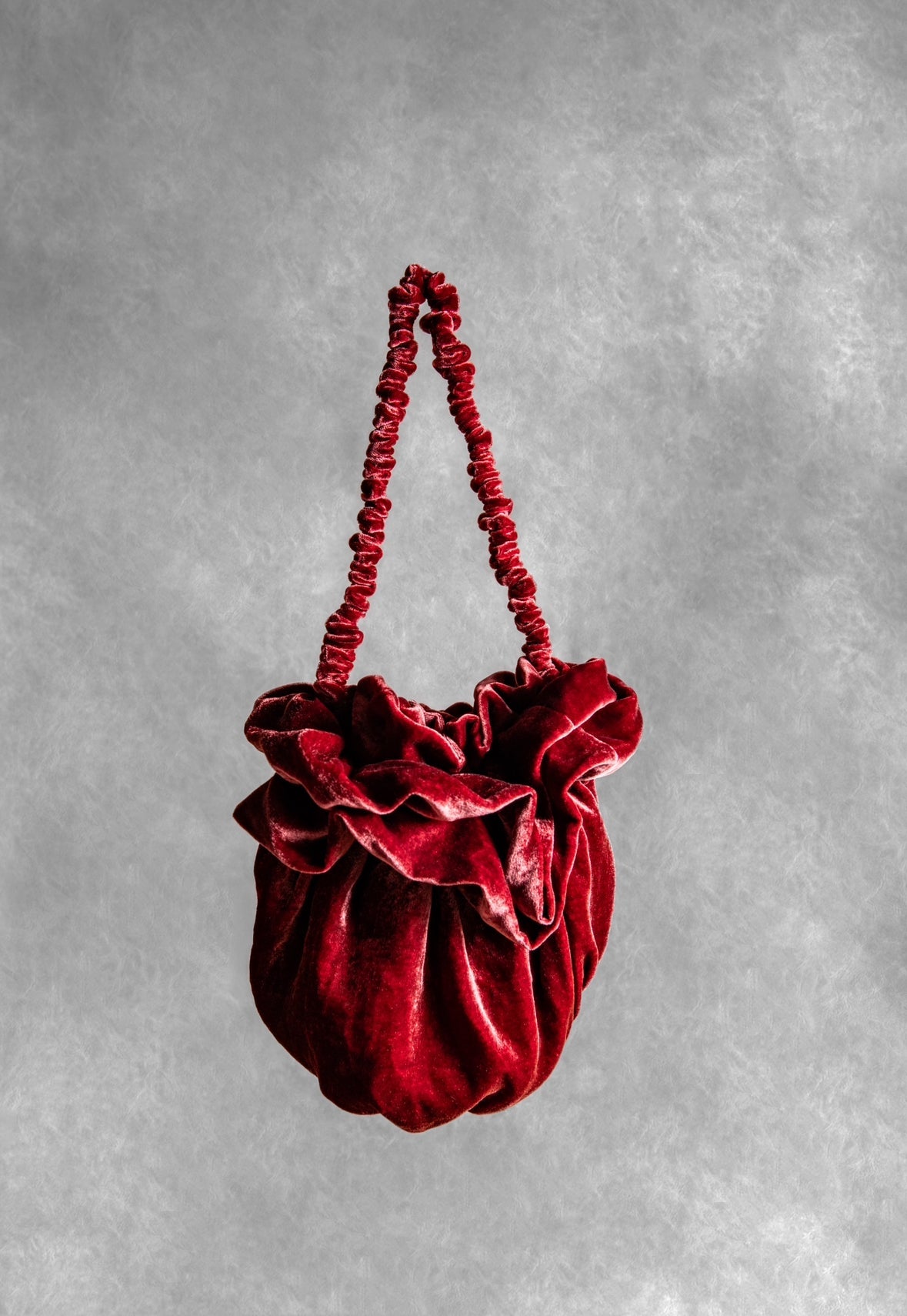 Crimson velvet Bloom bag with a ruffled top and gathered handle