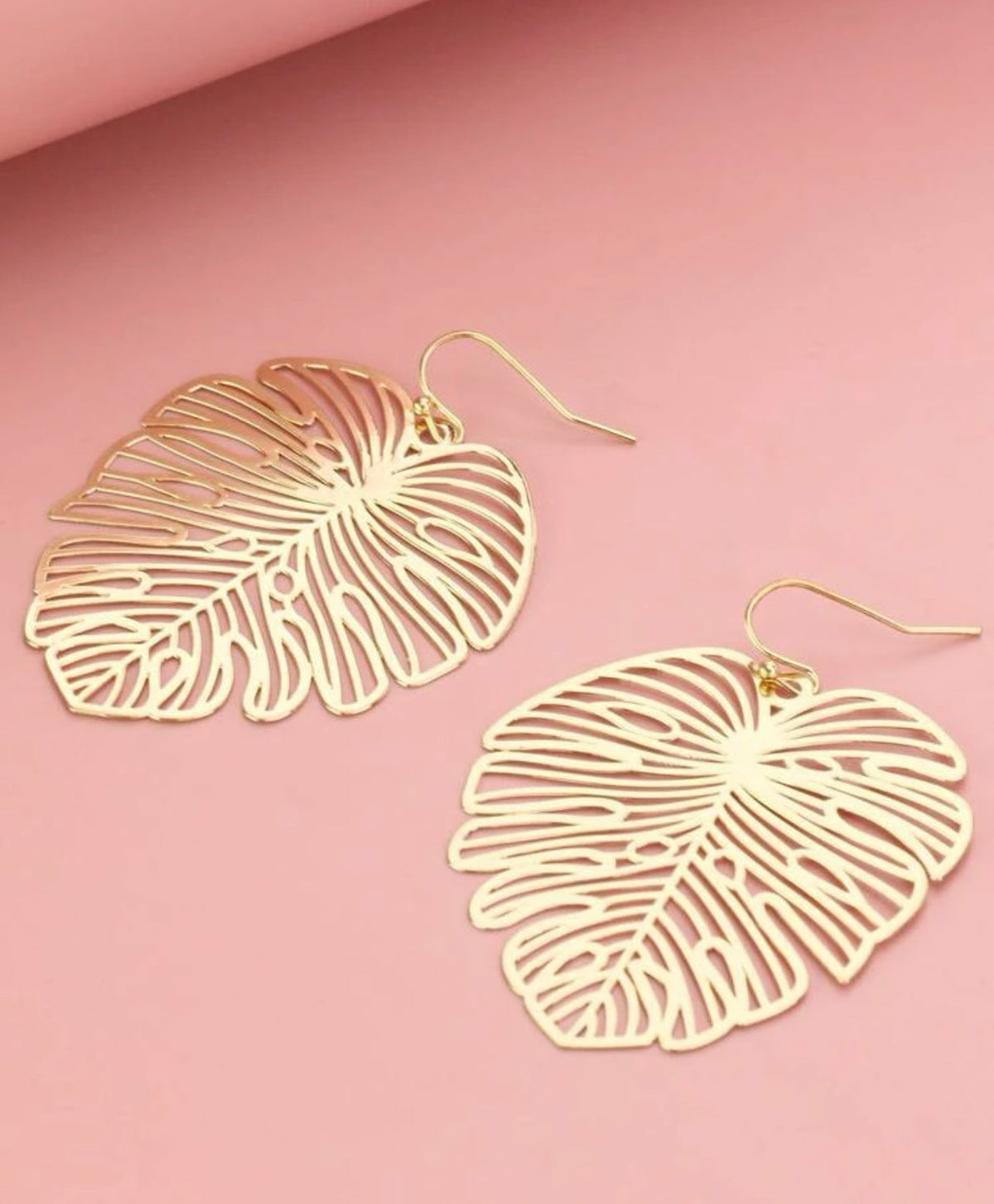 Gold leaf drop earrings with cutout filigree leaf design and gold hook backs