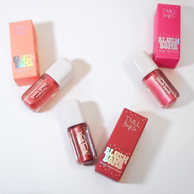 Assorted liquid blush bottles and boxes with pink, coral, and red shades.