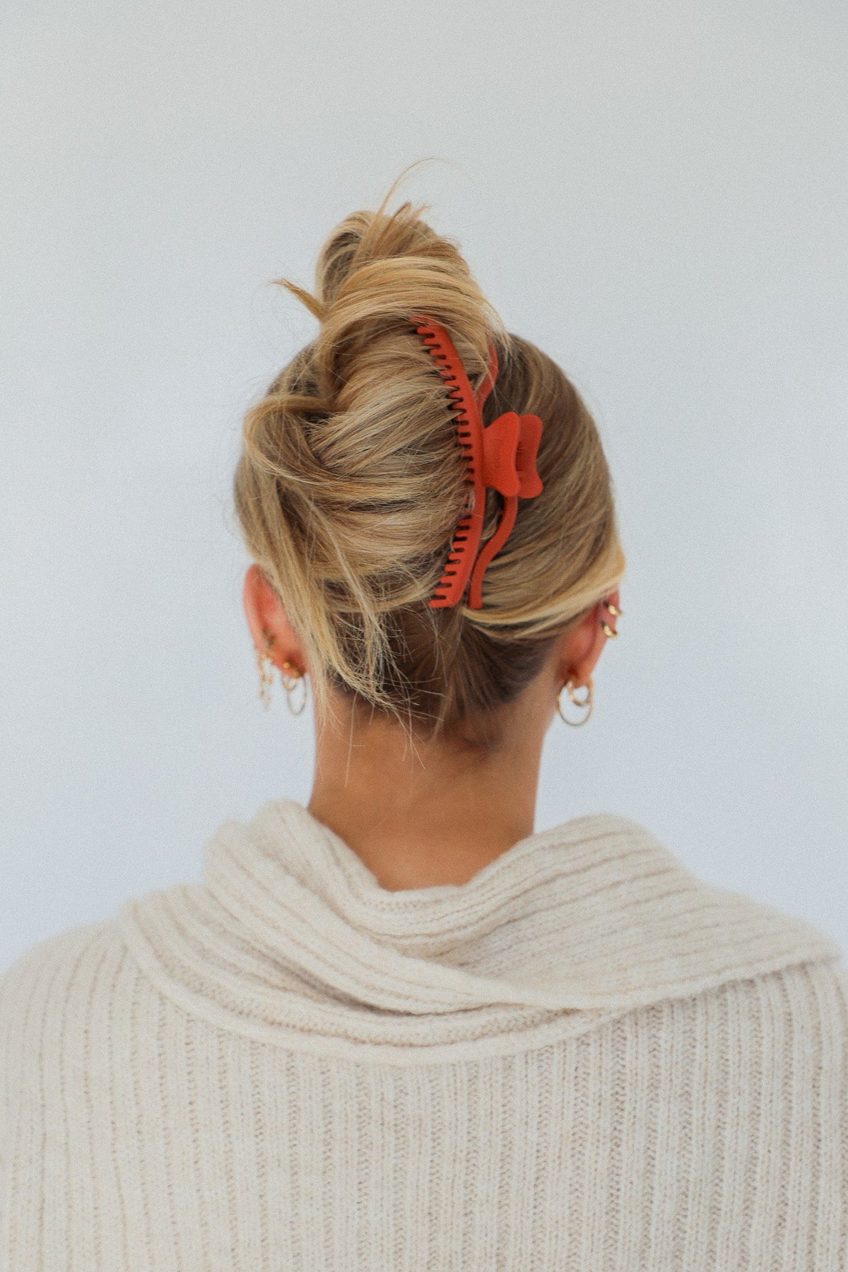 Orange wavy hold everything claw hair clip in a bun updo