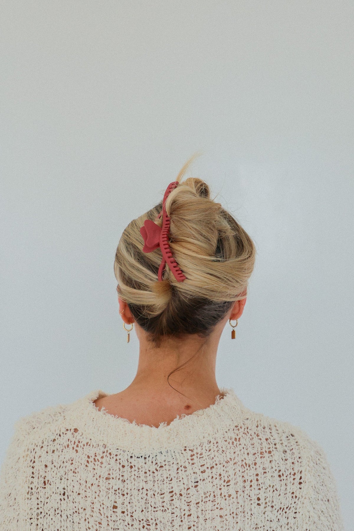 Pink wavy hold everything claw hair clip in a bun updo