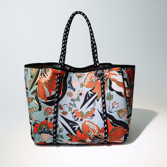Colorful floral patterned tote bag with black handles and reinforced front panel