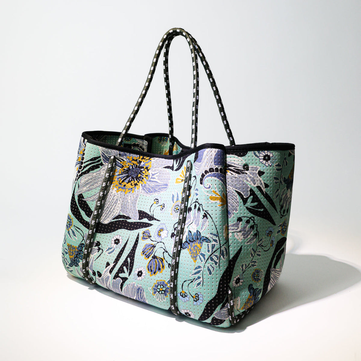Mint floral tote bag with black handles and structured zip-top