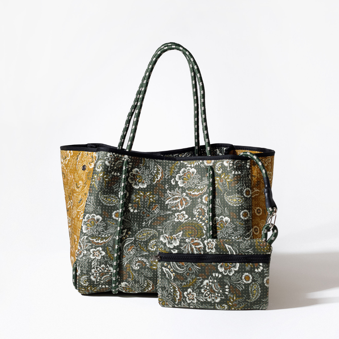 Forest-green paisley tote with black top edge, zip-style pocket detail, long handles