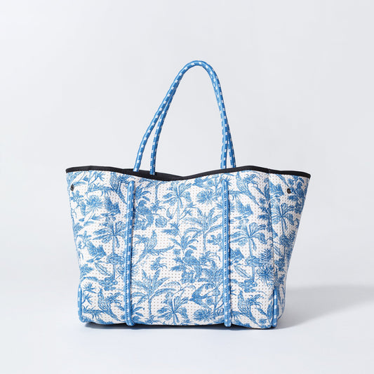 Blue and white tropical print tote bag with black trim and blue handles