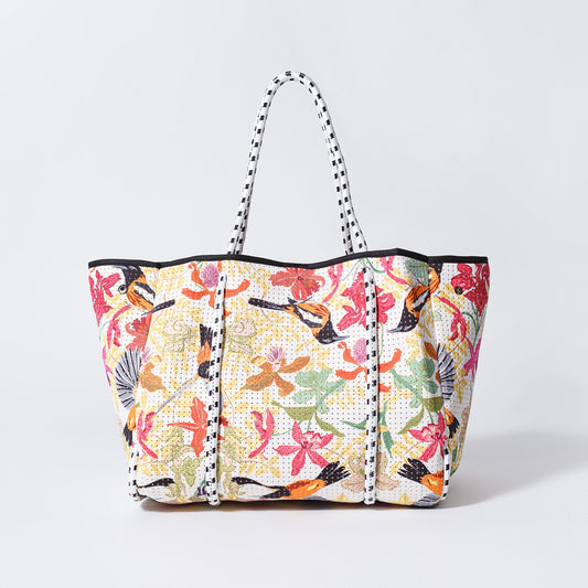 Floral patterned tote bag with top handles and black side trim