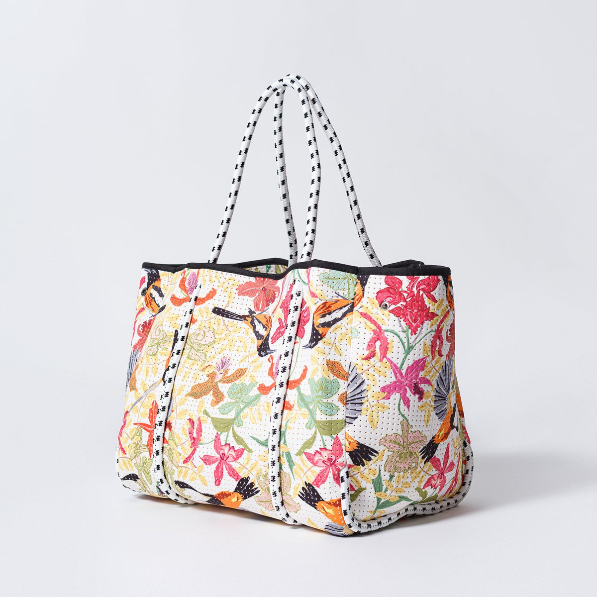 Floral canvas tote bag with black-edged handles and boxy bottom