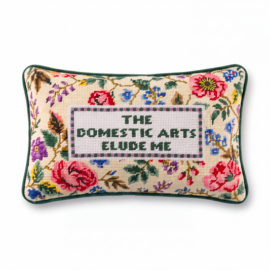 Needlepoint decorative pillow with embroidered floral border and central text panel