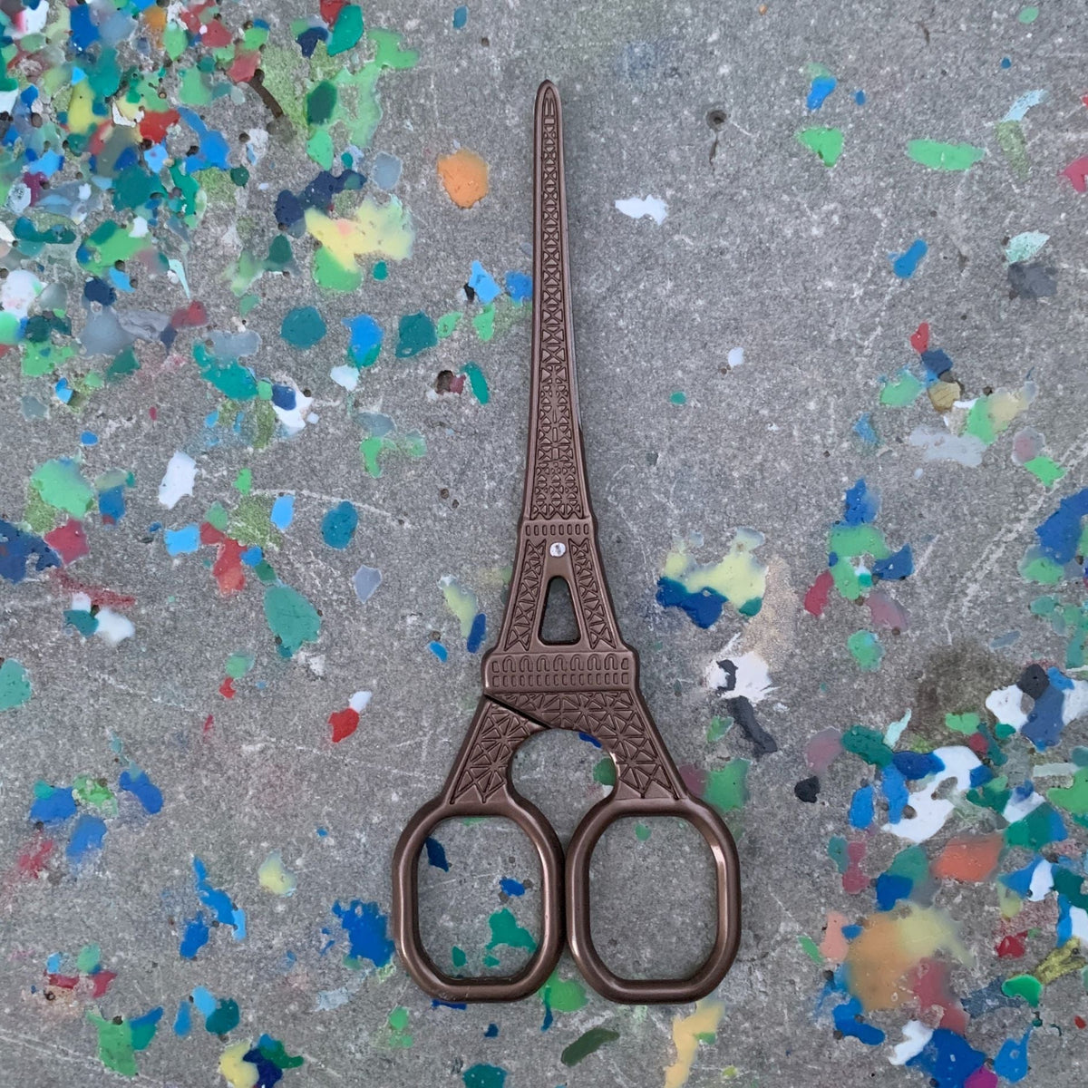 Eiffel Tower mini scissors in dark brown metallic finish, upright view, two finger loops.