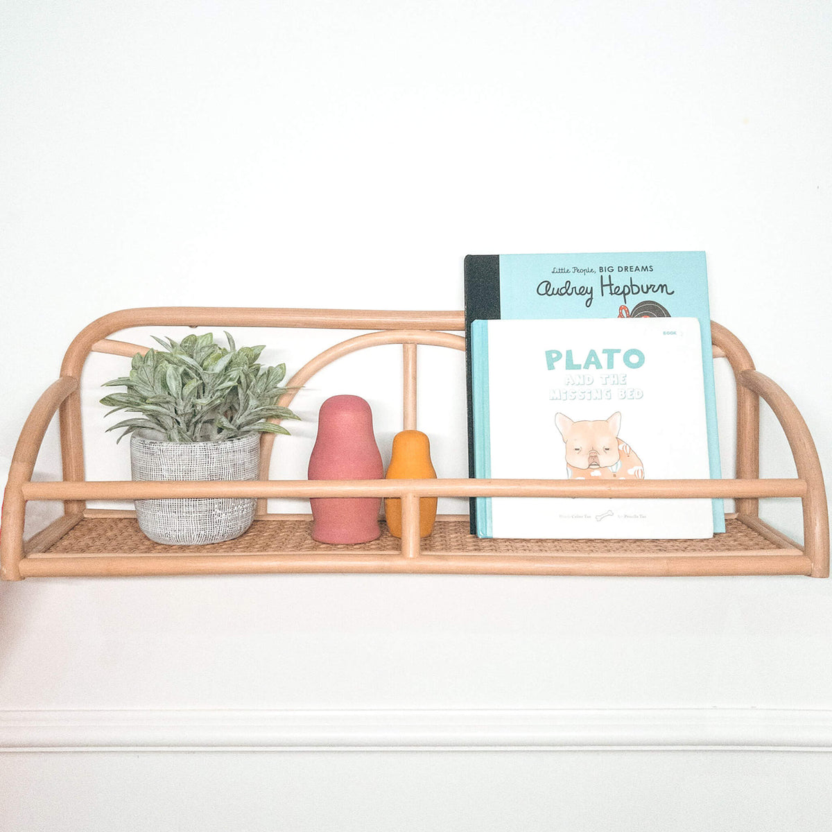 Natural rattan display shelf with woven base and curved dividers