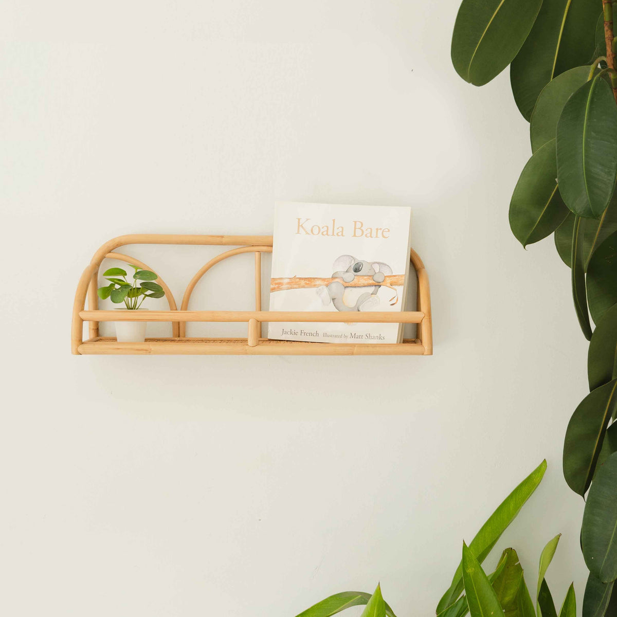 Eloise wall display shelf in natural rattan with arched rails and a front guard